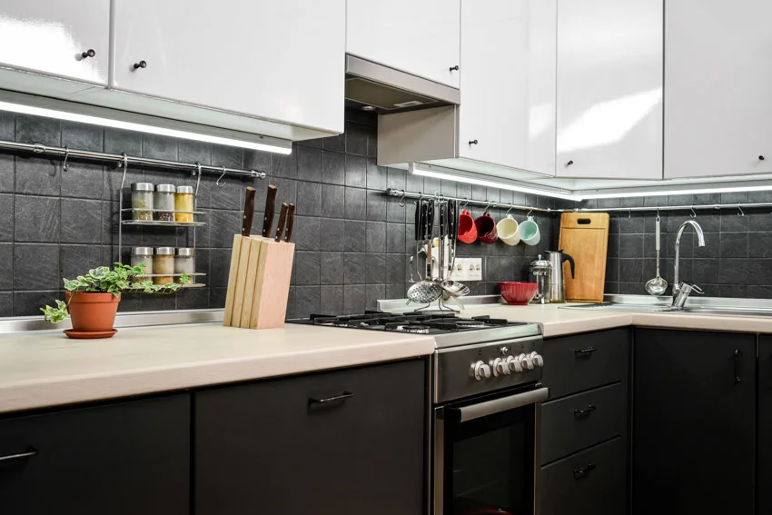 Kitchen with textured matte backsplash countertop, cabinets, oven, sink, and faucet