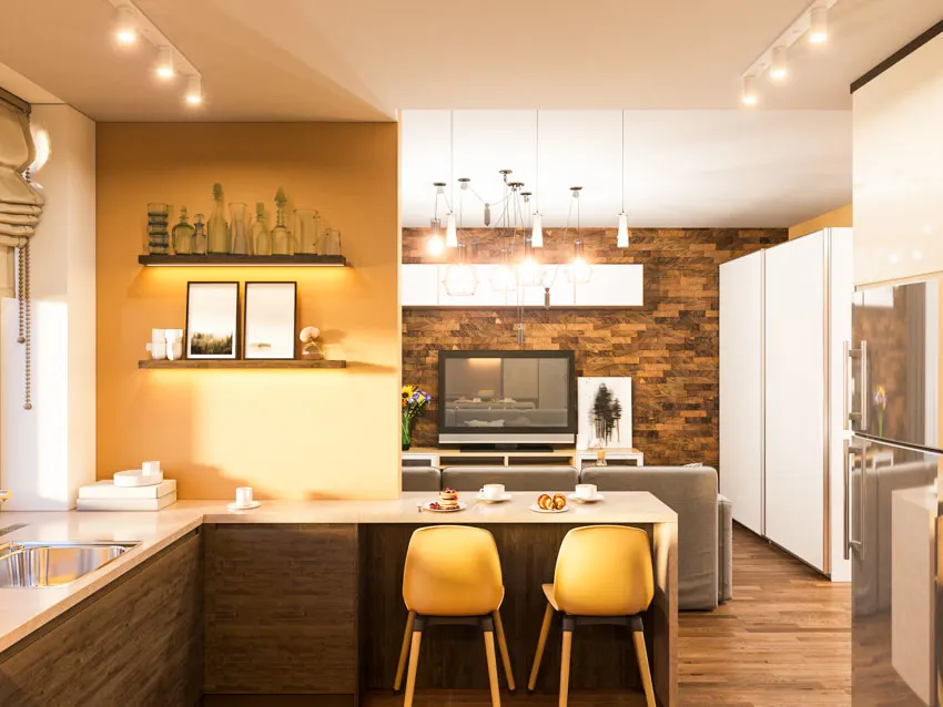 Kitchen with wood floor chairs, track lights, countertops, and yellow walls