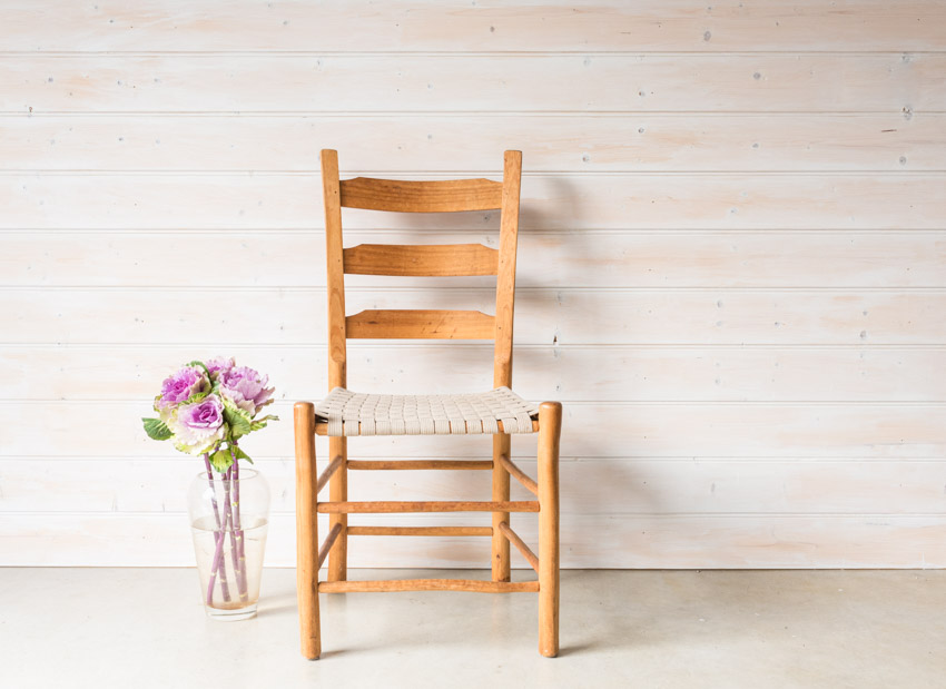 Accent chair next to a vase with flowers