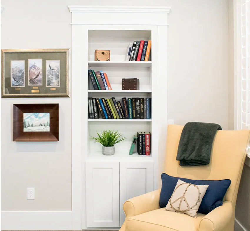 Living room with books, chair, pillow, and cabinet murphy door