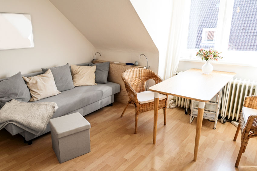 light gray couch under white stairs