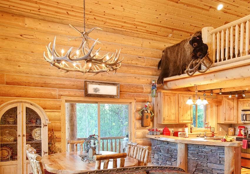 A log home cabin interior with antler chandelier