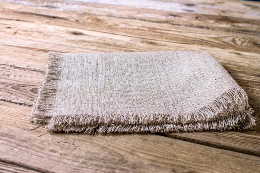 Loose weave linen fabric cloth on wood surface