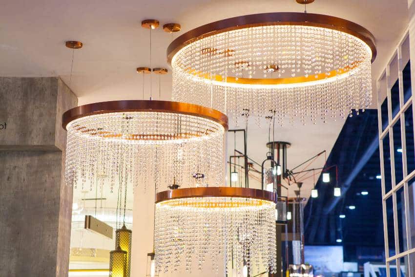 Luxury expensive beaded chandeliers hanging under ceiling