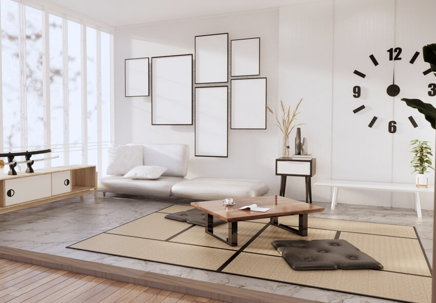 Minimalist modern Japanese room with white sofa, wooden coffee table on tatami floor mat and a wall clock