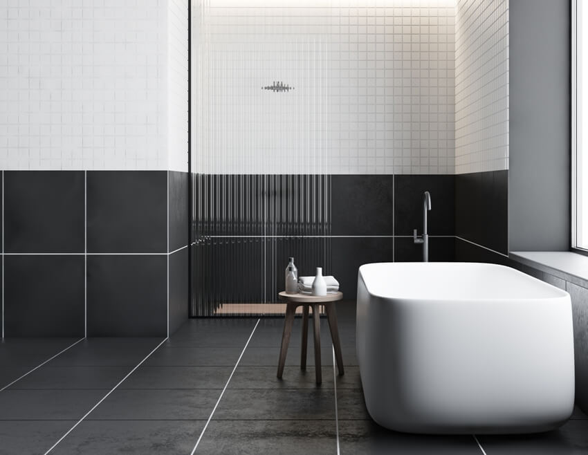 Modern bathroom with bathtub and black large format tile flooring