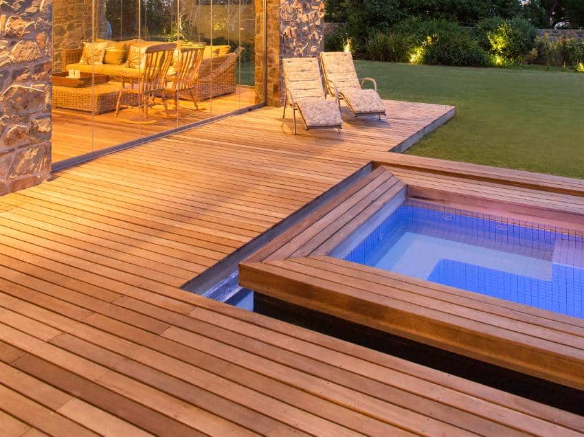 A modern house with swimming pool and teak wood decking