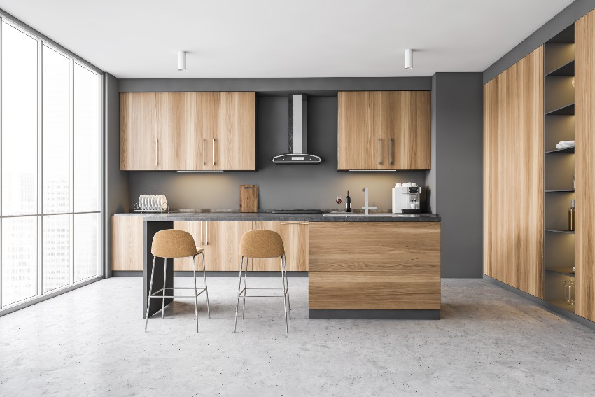 Kitchen with laminated wood cabinets, center island with counter