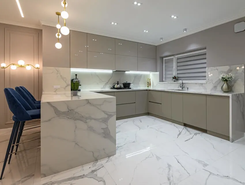Modern white marble kitchen with large format tile floors, gray cabinets and blue high chairs