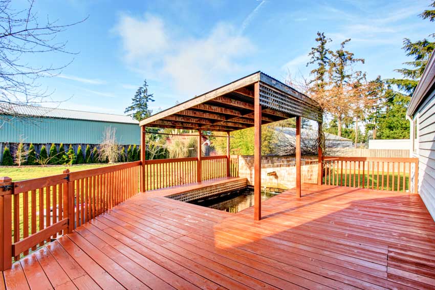 Outdoor area with redwood decking, railings, and shade