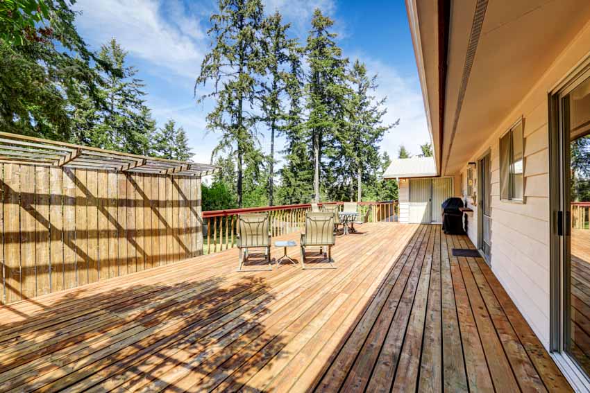 Pressure treated wood deck with lounge chairs, and wooden fences