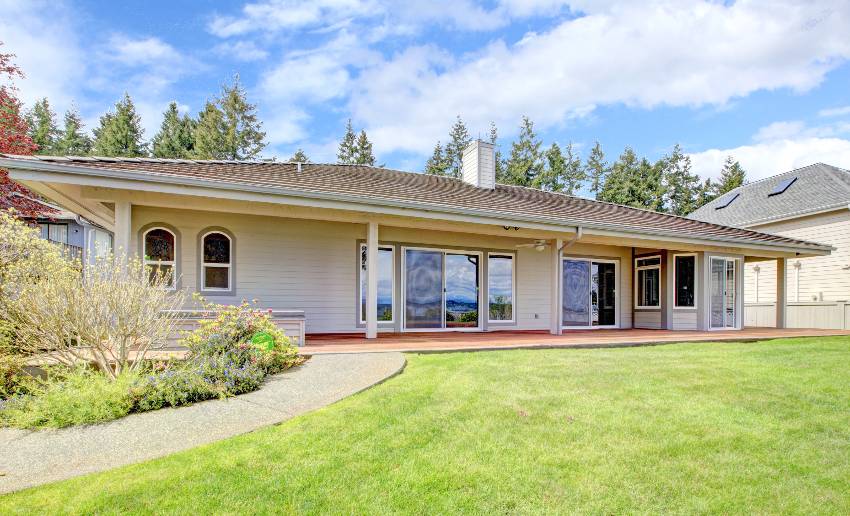 Single story house with modern neutral paint, backyard column porch, lawn and walkway