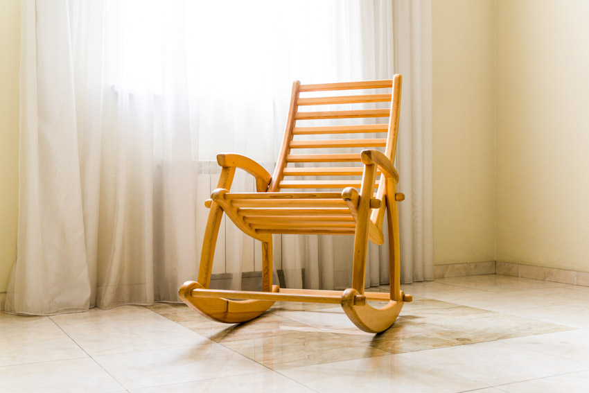 Room with rocking chair, and window curtains