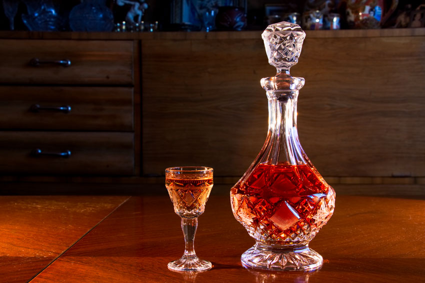 Rum decanter with small glass next to it