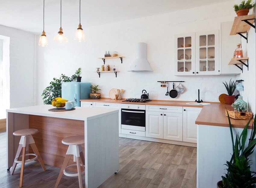 Kitchen with open shelves, waterfall island and plants