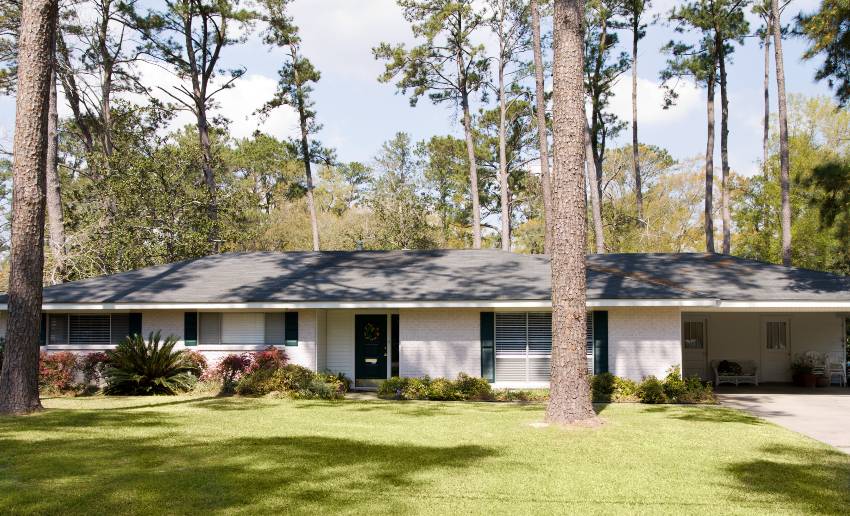 A simple ranch residence with wide front yard and big trees