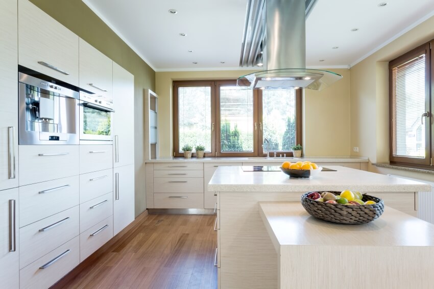 Kitchen with island, wooden parquet floors and fruit basket