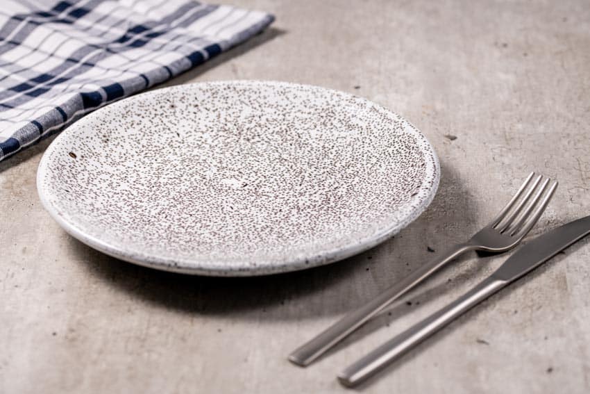 Stoneware plate with table, napkin, fork, and knife