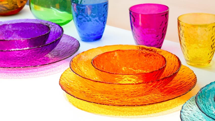 Table with colored glass plates and cups