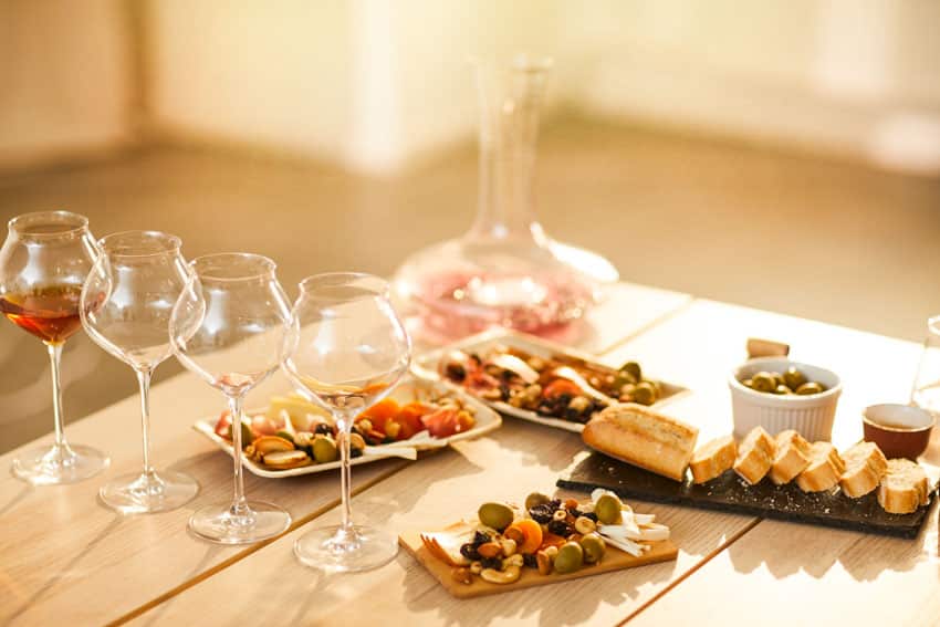 Table with special serving plates and wine glasses
