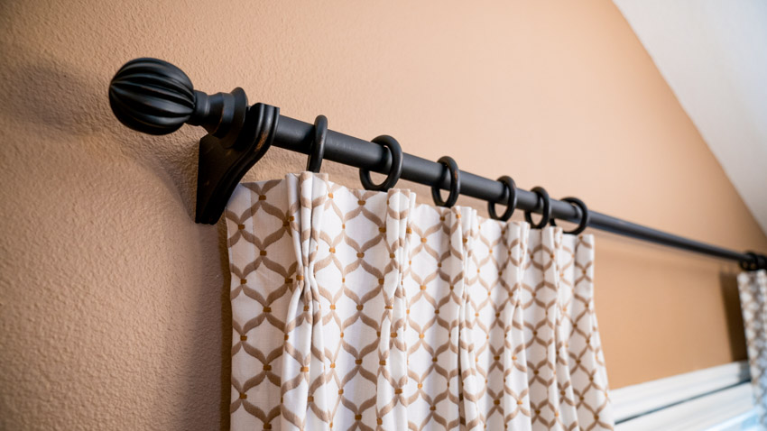 Thick black pole with patterned curtain