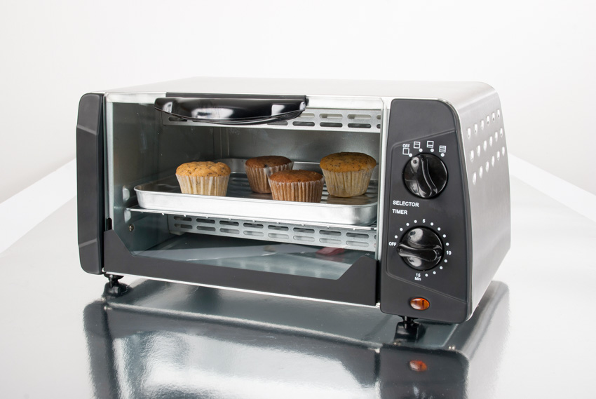 Toaster oven with muffins in it for kitchens
