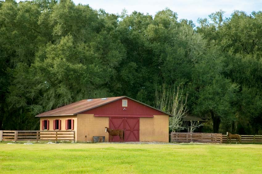 Trailside barn made of wood with doors, windows, and fences