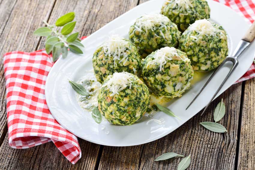 White serving platter with spinach appetizers 