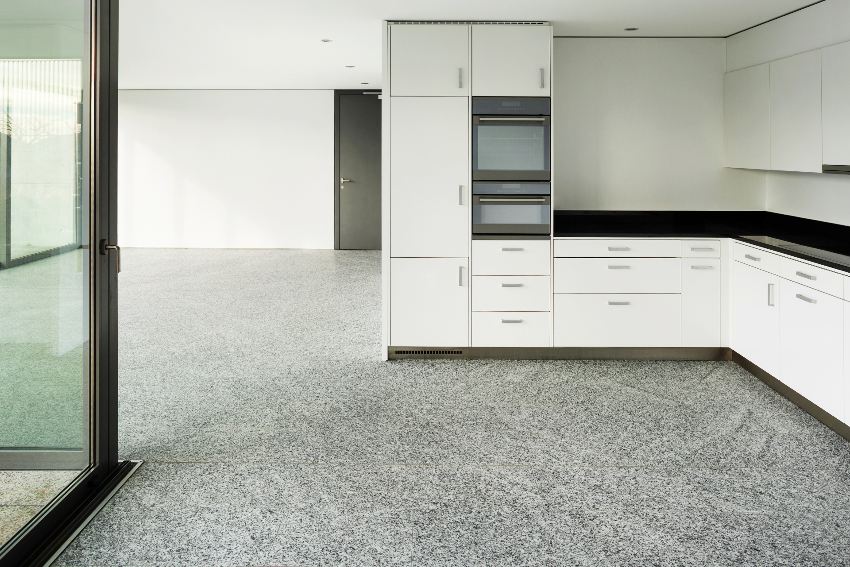 Kitchen and living room with white walls and cabinets