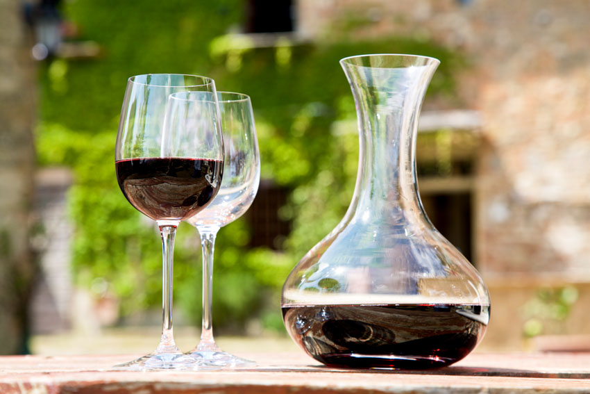 Wine carafe with glasses next to it