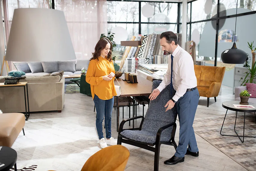 Home store staff presenting arm chair