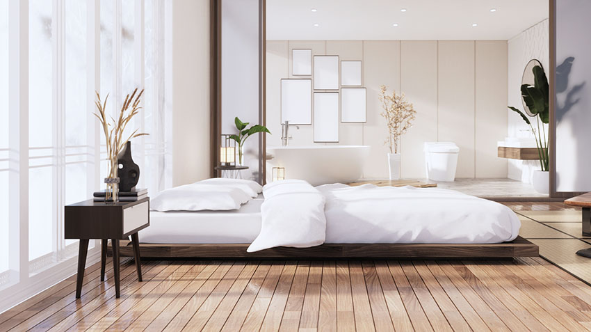 Large modern bedroom with wood flooring tatami bed bedside table large bathroom