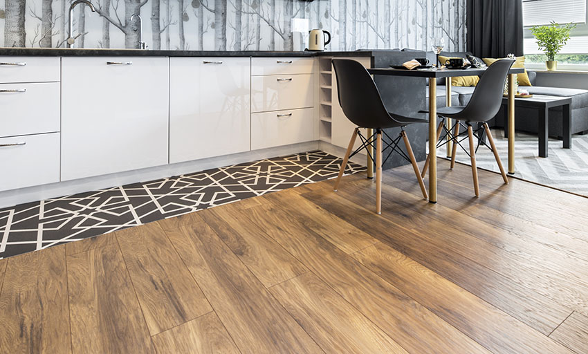 Modern kitchen with wallpaper backsplash white cabinets wood flooring