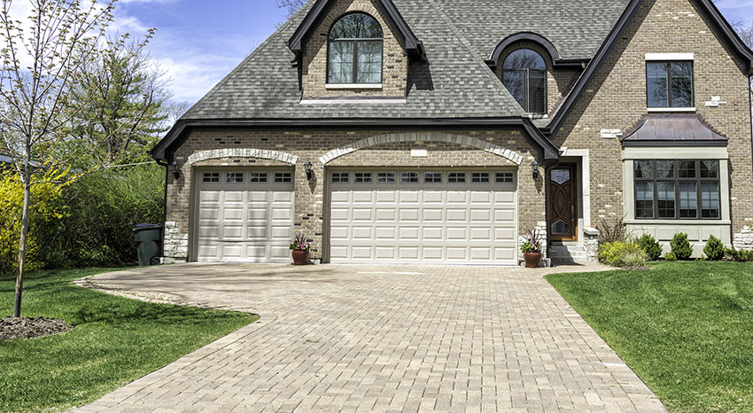 Traditional house with paver driveway three car garage