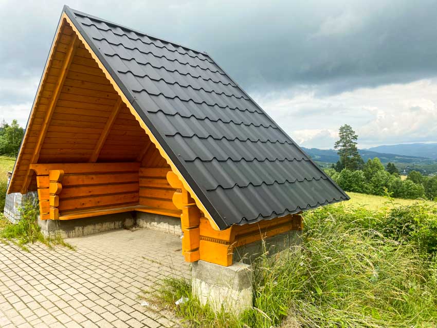 Wood A-frame shed with shingle roof