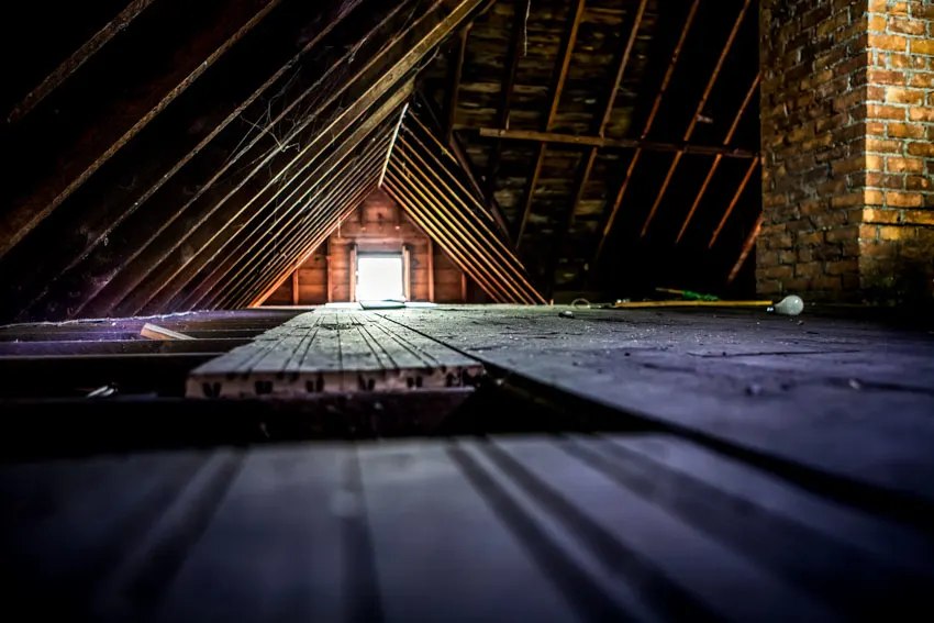 Attic inside a house with window and brick column