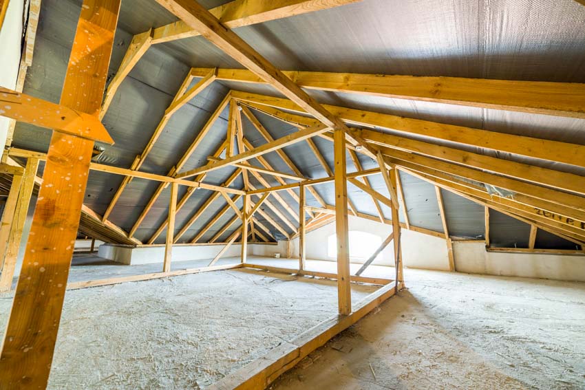 Attic crawl space with wood beams and metal panels