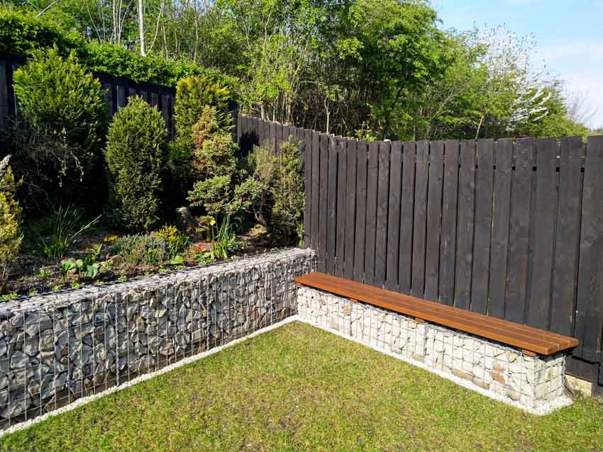 Backyard with plants, bench and fence