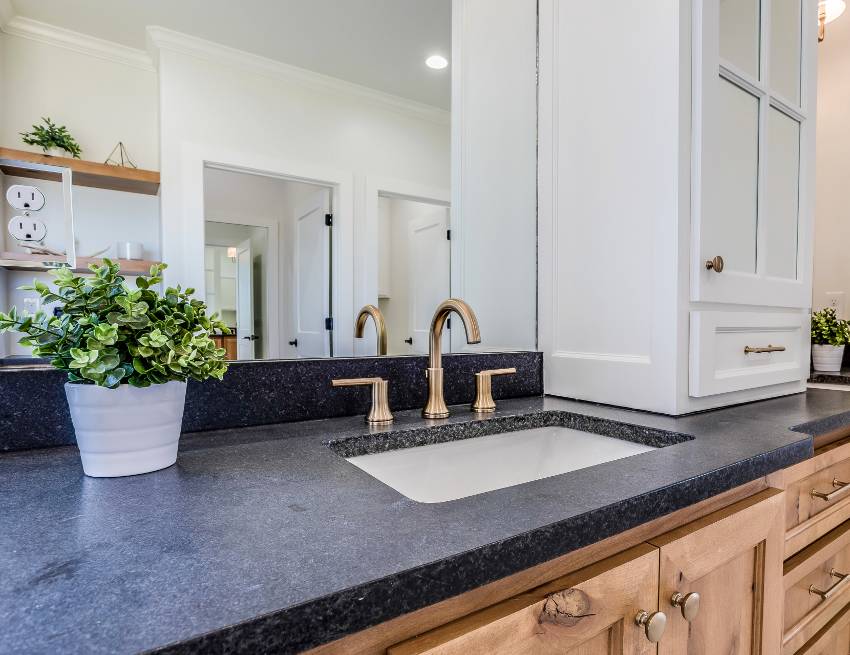 Bathroom vanity with solid oak classic style cabinets, black galaxy granite countertop and brass fixtures