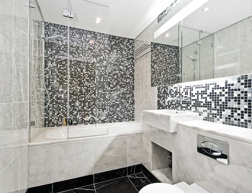 Bathroom with alcove tub, tile floor, vanity mirror and countertop