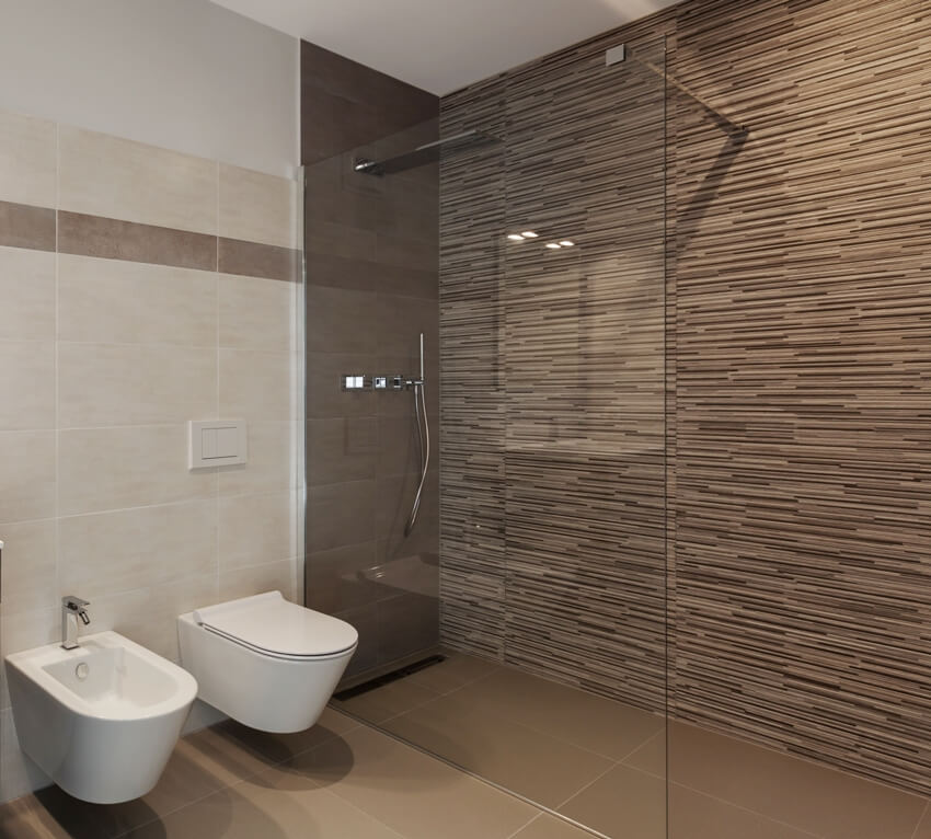 Bathroom with two toilets and shower with glass division and beautiful laminate walls