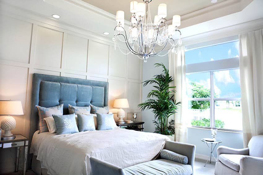 Bedroom with cream wall headboard curtains tray ceiling chandelier