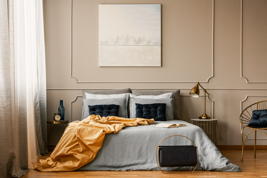 Bedroom with nightstands, chair, and beige wall