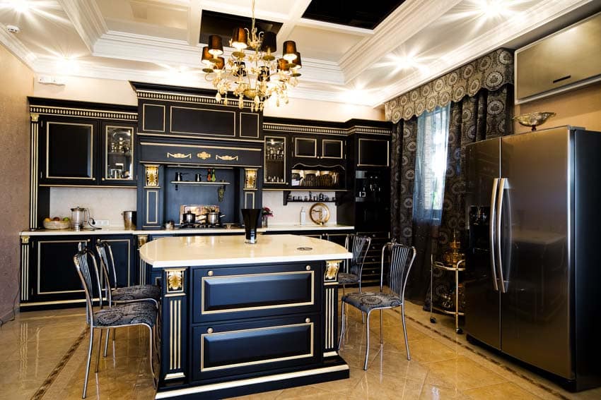 Black kitchen with chandelier, island, table, chairs, cabinets, refrigerator, and curtains