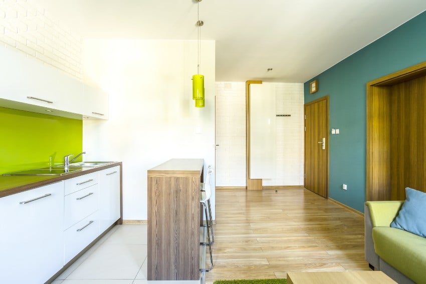 Bright white kitchen interior in wood, blue and lime green tone