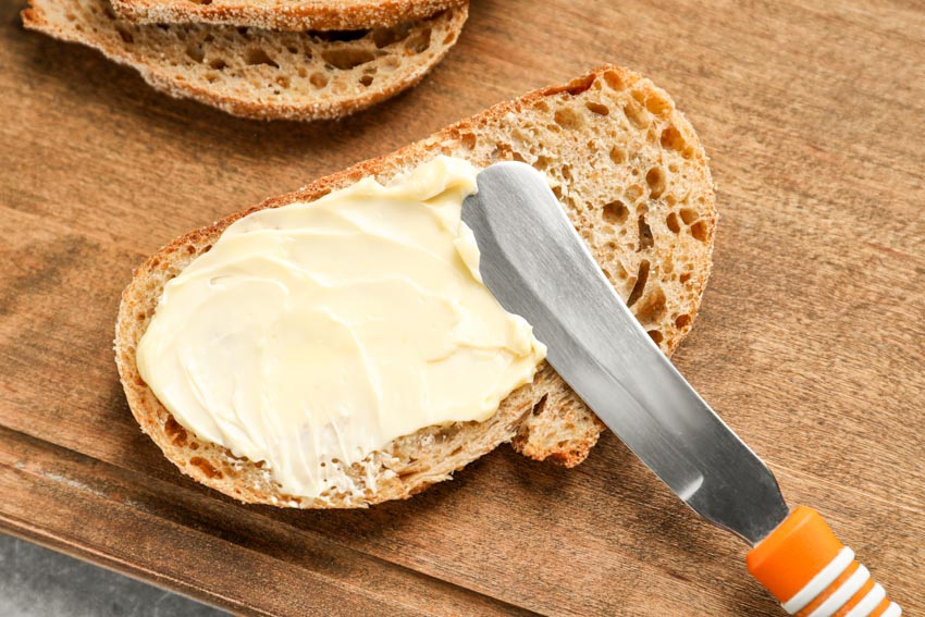 Butter spreader on a piece of bread