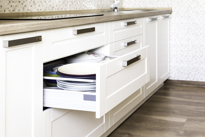 Contemporary cabinet hardware with open drawer, and countertop