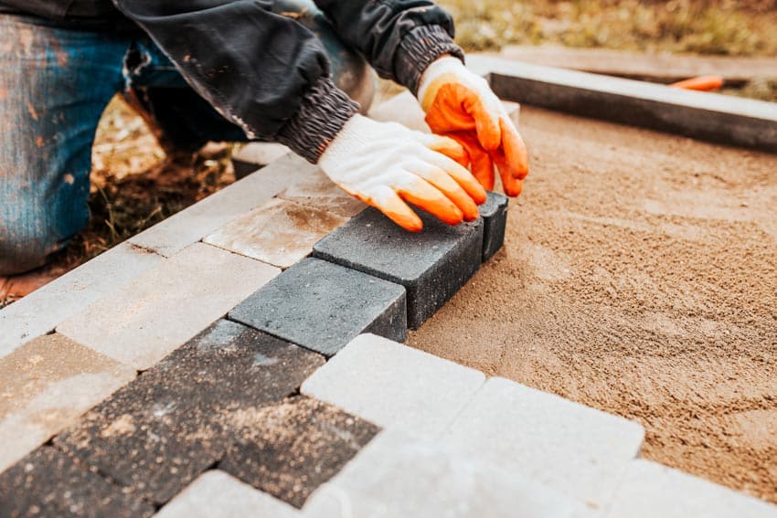 Contractor laying pavers down pavers