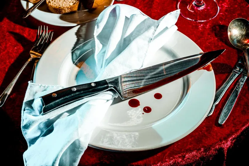 A silver knife on top of white plate
