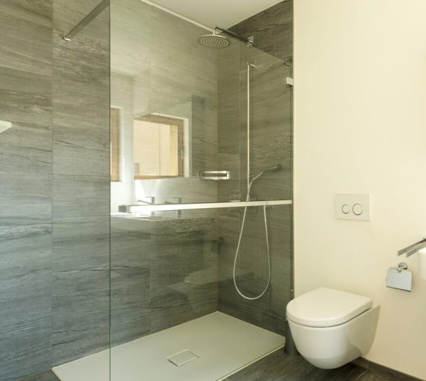 Laminate Shower Walls Pros And Cons   Empty Modern Bathroom Interior With Shower And Gray Stone Like Laminate Walls Ss 608x544 